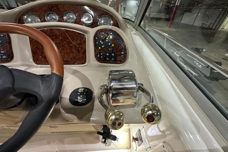  Yacht Photos Pics 2004 Sea Ray 340 Sundancer helm with wood accents and throttle controls.