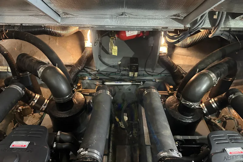  Yacht Photos Pics Engine room of a 2004 Sea Ray 340 Sundancer with visible hoses and components.