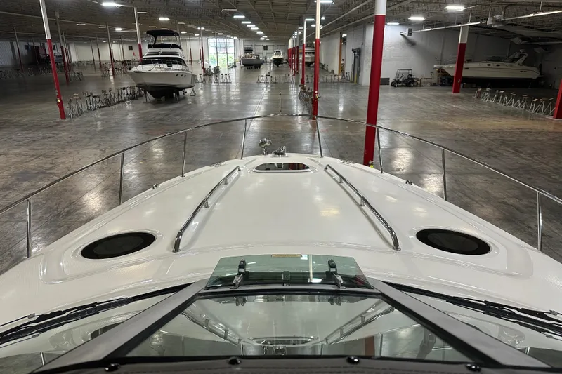  Yacht Photos Pics 2004 Sea Ray 340 Sundancer in a spacious indoor showroom with other boats.