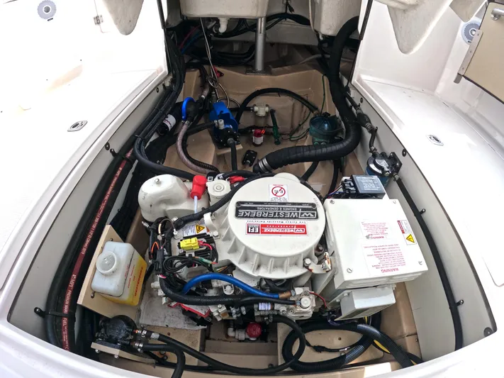  Yacht Photos Pics Engine compartment of a 2020 Ranger Tugs R-27 boat, showcasing mechanical components and wiring.