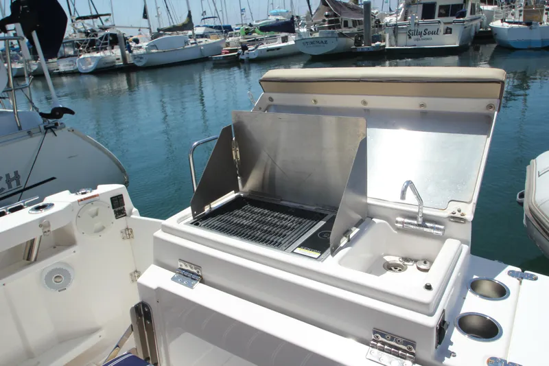 Yacht Photos Pics Outdoor kitchen on 2020 Ranger Tugs R-27 boat with grill and sink in marina.