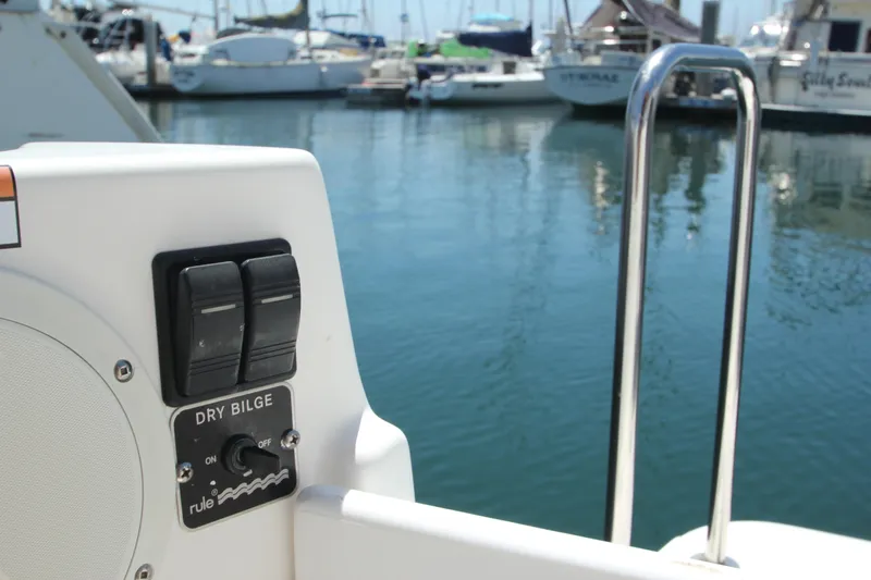  Yacht Photos Pics Ranger Tugs R-27 boat control panel with dry bilge switch, marina background, 2020 model.