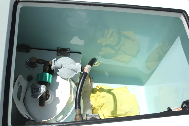  Yacht Photos Pics Storage compartment of 2020 Ranger Tugs R-27 boat with equipment and yellow cloth.