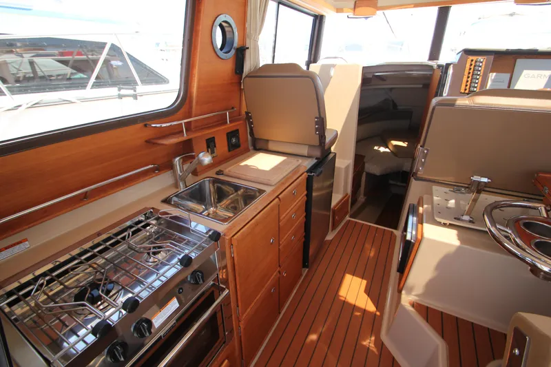  Yacht Photos Pics Interior of 2020 Ranger Tugs R-27 boat with kitchen and seating area.