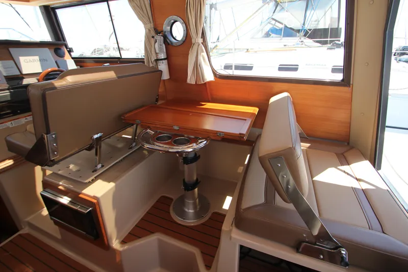  Yacht Photos Pics 2020 Ranger Tugs R-27 interior with seating, table, and window view.