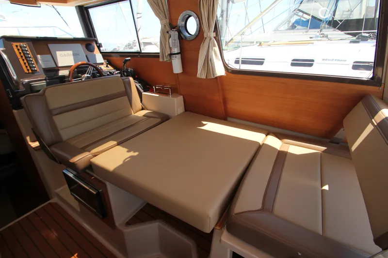  Yacht Photos Pics 2020 Ranger Tugs R-27 interior with convertible seating and wooden accents.