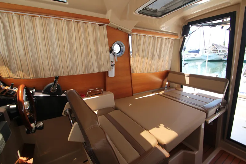  Yacht Photos Pics Interior of 2020 Ranger Tugs R-27 boat with seating and wooden accents.