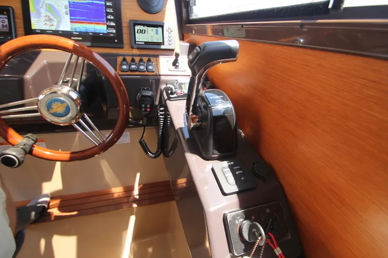  Yacht Photos Pics Interior helm of 2020 Ranger Tugs R-27 with steering wheel and control panel.