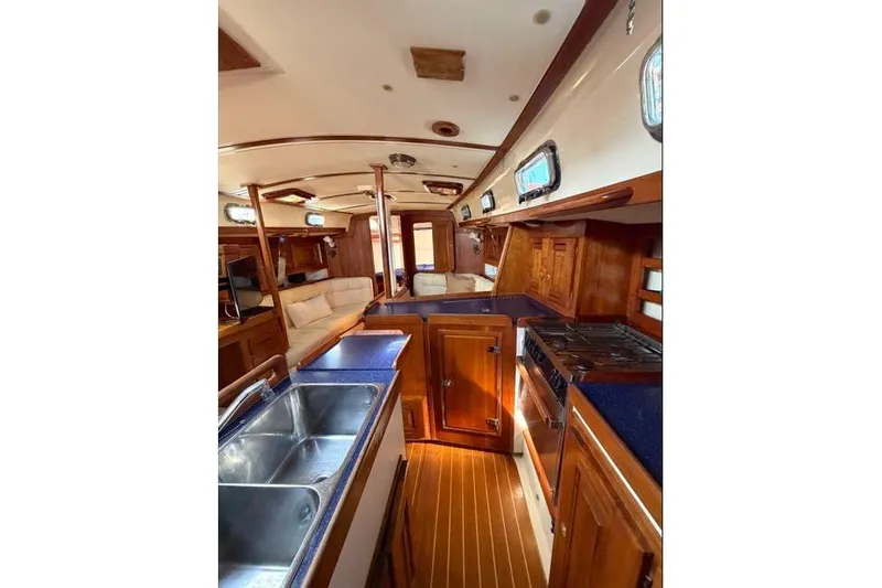 R'liberty Yacht Photos Pics Interior of 2001 Tartan 3700 yacht with wooden cabinetry and modern amenities.