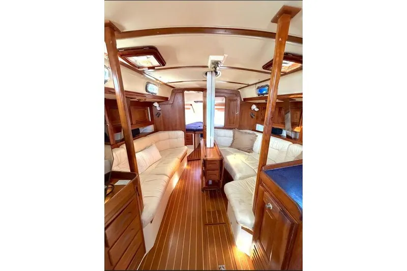R'liberty Yacht Photos Pics Luxurious interior of 2001 Tartan 3700 sailboat with wood finish and plush seating.