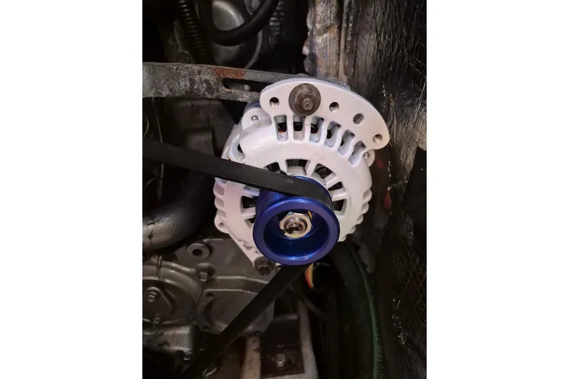 R'liberty Yacht Photos Pics Close-up of Tartan 3700 alternator, 2001 model, with blue pulley and belt.