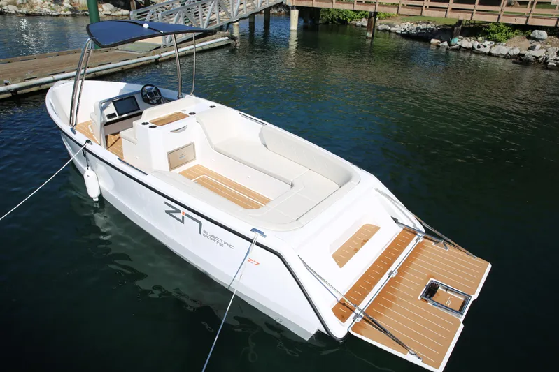  Yacht Photos Pics 2025 Zin Boats Z7 electric boat docked, featuring sleek design and spacious seating.