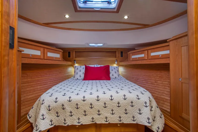  Yacht Photos Pics Luxurious cabin interior of 2025 Sabre 45 Salon Express yacht with nautical bedding.