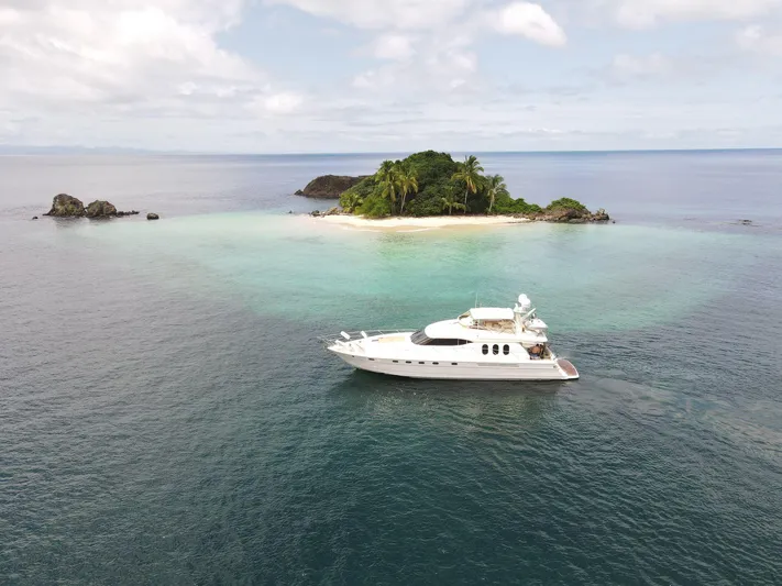  Yacht Photos Pics Viking Princess 68 Sport Cruiser yacht near tropical island, 2003 model, serene ocean view.