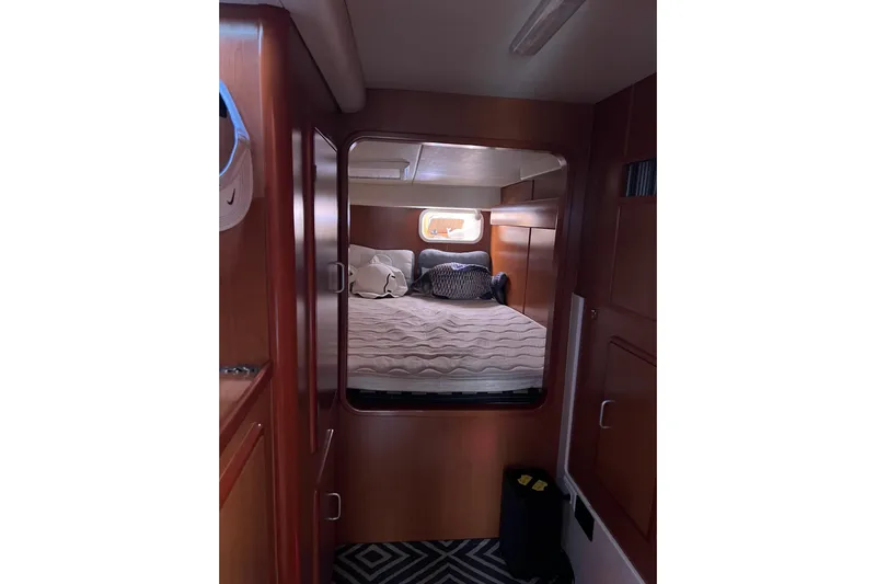  Yacht Photos Pics Cozy cabin interior of 2010 Leopard 40 catamaran with bed and wooden furnishings.