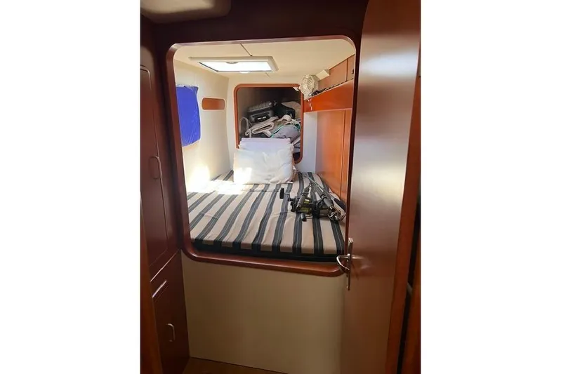  Yacht Photos Pics Cabin interior of 2010 Leopard 40 yacht with striped bedding and storage items.