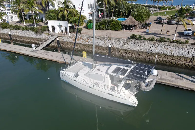  Yacht Photos Pics 2010 Leopard 40 catamaran docked in marina with solar panels and tropical surroundings.
