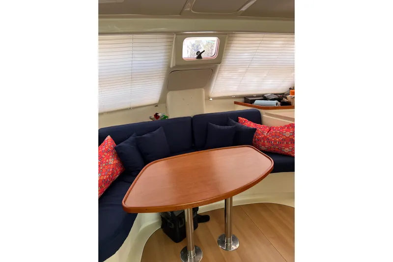  Yacht Photos Pics Interior of 2010 Leopard 40 yacht with wooden table and colorful cushions.