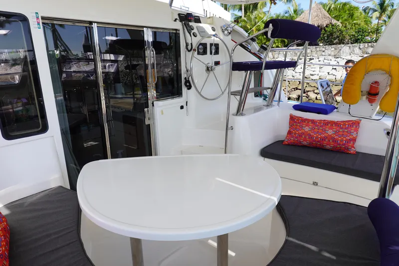  Yacht Photos Pics 2010 Leopard 40 yacht interior with seating, table, and helm station, featuring vibrant cushions.