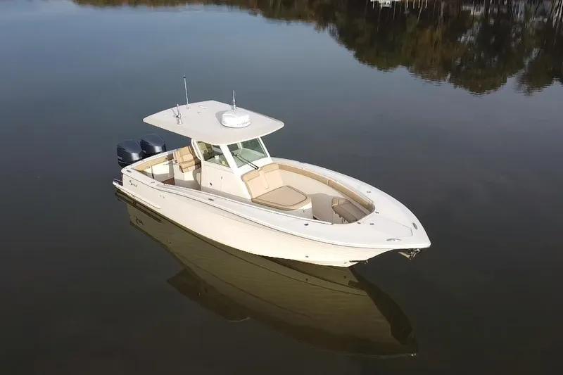 Yacht Photos Pics 2016 Scout 300 LXF boat on calm water, featuring dual engines and sleek design.