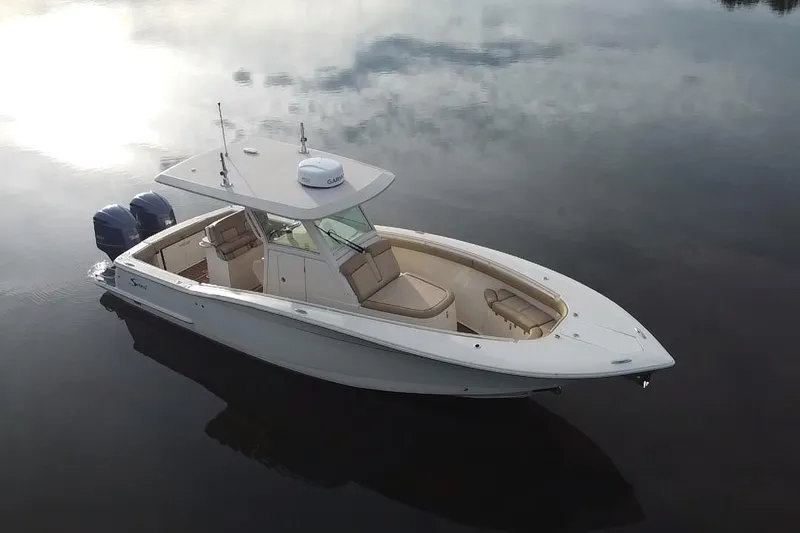  Yacht Photos Pics 2016 Scout 300 LXF boat on calm water, featuring dual engines and sleek design.