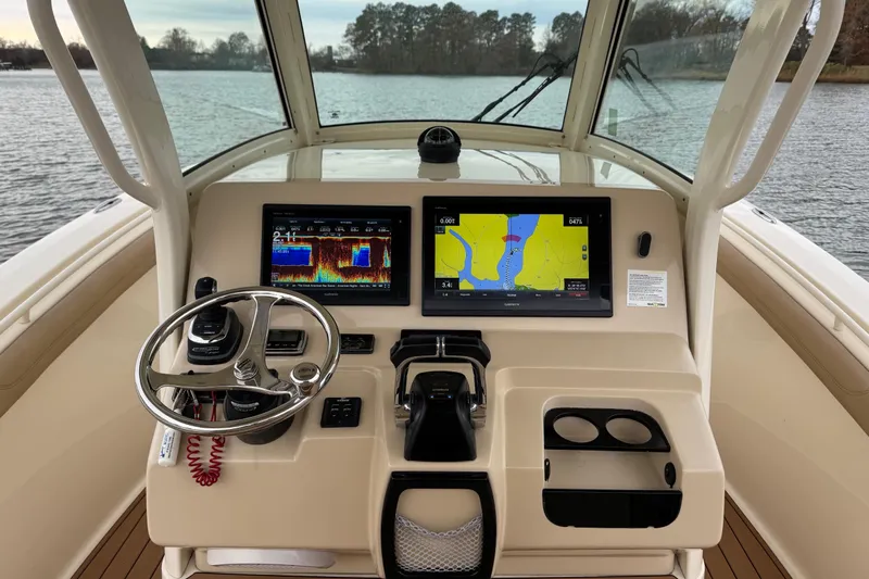  Yacht Photos Pics Helm of 2016 Scout 300 LXF boat with navigation screens and steering wheel.