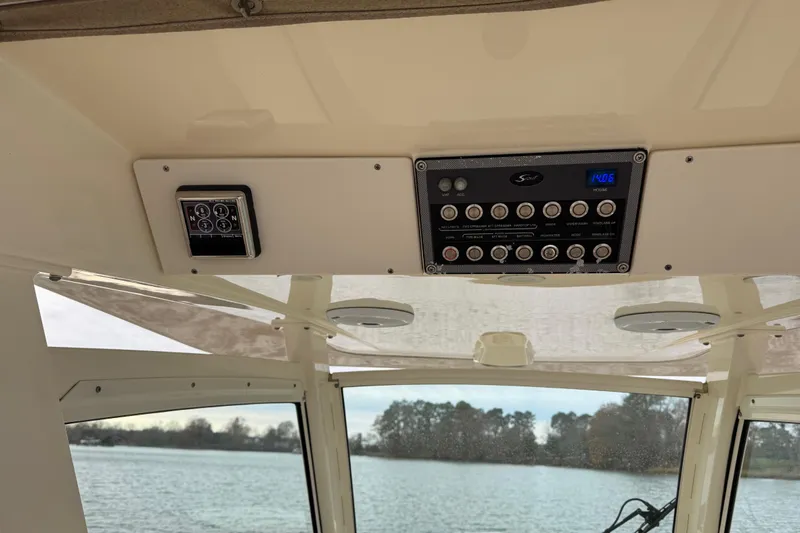  Yacht Photos Pics 2016 Scout 300 LXF boat dashboard with control panel and water view.