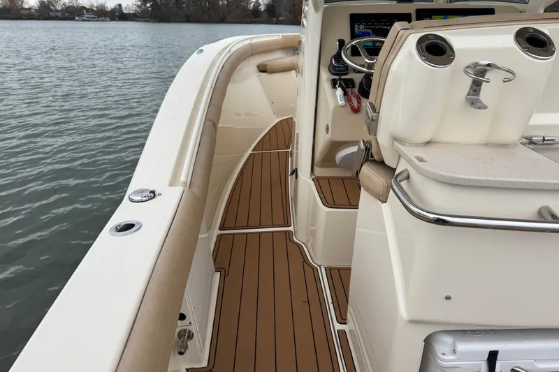  Yacht Photos Pics 2016 Scout 300 LXF boat interior with teak flooring and steering console.