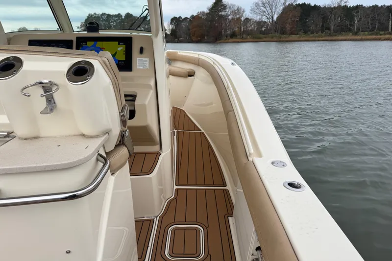  Yacht Photos Pics 2016 Scout 300 LXF boat interior with wood flooring, dashboard, and water view.