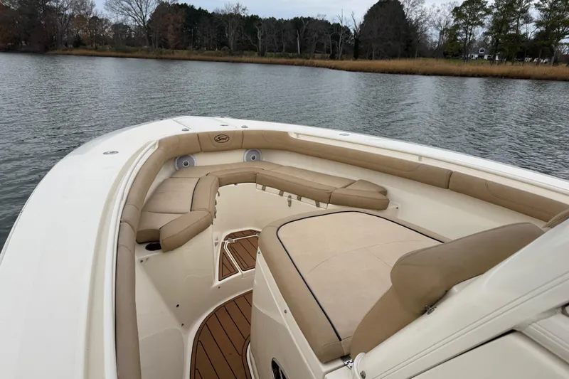 Yacht Photos Pics 2016 Scout 300 LXF boat interior with beige seating on calm water.