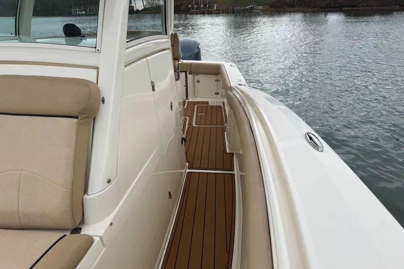  Yacht Photos Pics 2016 Scout 300 LXF boat with tan seating and wooden deck by the water.