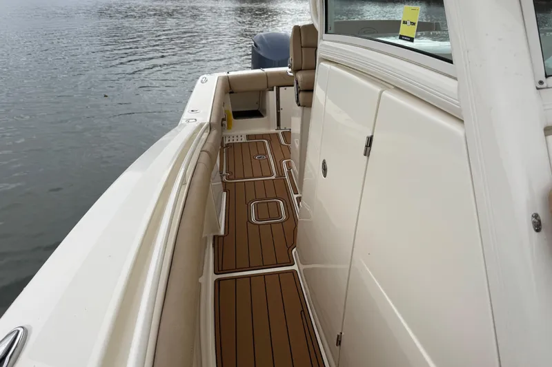  Yacht Photos Pics 2016 Scout 300 LXF boat with teak deck, docked on calm water.