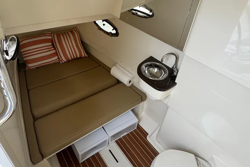  Yacht Photos Pics 2016 Scout 300 LXF cabin interior with bed, sink, and toilet.