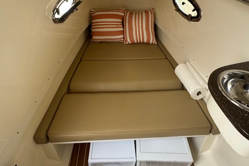  Yacht Photos Pics 2016 Scout 300 LXF cabin interior with cushions, sink, and storage.