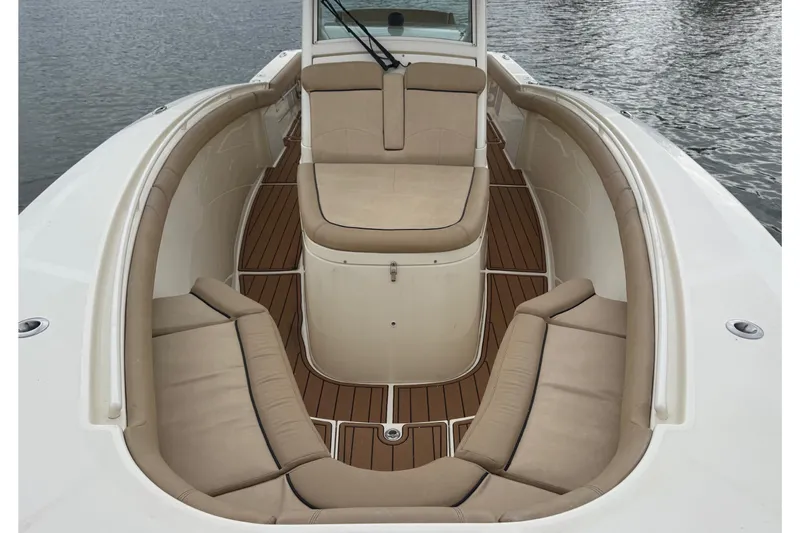  Yacht Photos Pics 2016 Scout 300 LXF boat interior with beige seating and wooden deck.