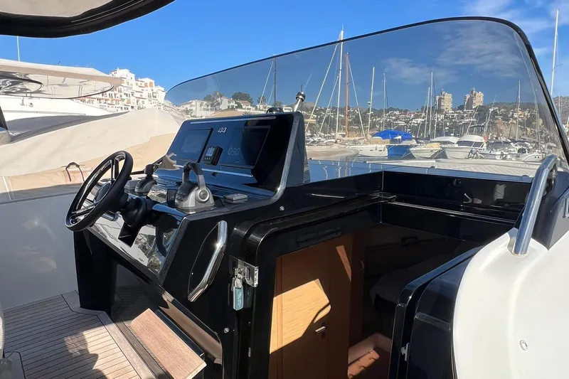  Yacht Photos Pics Helm of 2022 Solaris Power 44 Open yacht in a marina setting.