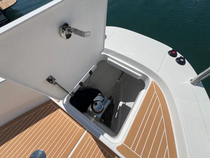 San #155 In Stock Yacht Photos Pics Open anchor compartment on 2024 Nimbus T9 boat with teak deck.