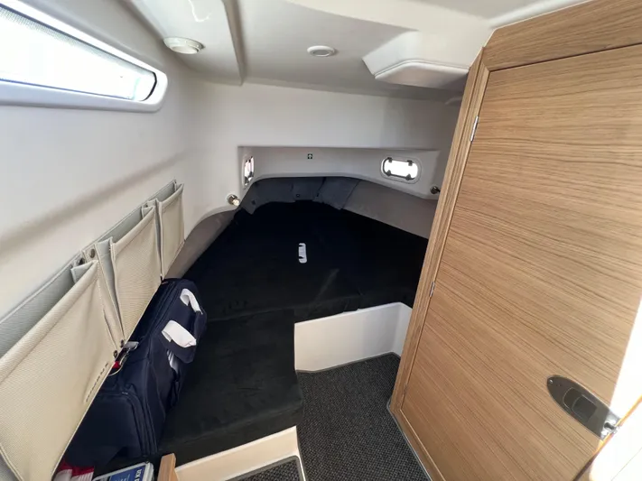 San #155 In Stock Yacht Photos Pics Cozy cabin interior of 2024 Nimbus T9 boat with modern wood finish.