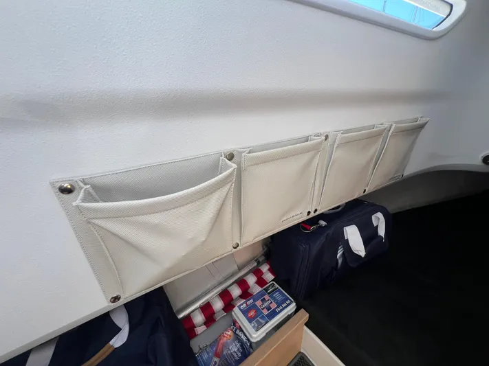 San #155 In Stock Yacht Photos Pics Interior storage pockets in a 2024 Nimbus T9 boat cabin.