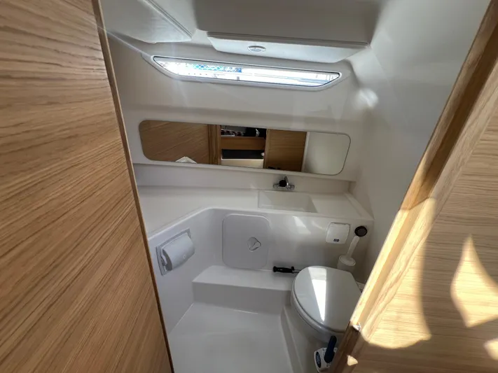San #155 In Stock Yacht Photos Pics Modern bathroom interior in 2024 Nimbus T9 boat, featuring sleek design and natural lighting.