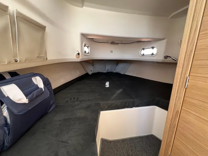 San #155 In Stock Yacht Photos Pics Cozy cabin interior of 2024 Nimbus T9 boat with comfortable bedding and storage.