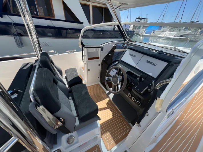 San #155 In Stock Yacht Photos Pics 2024 Nimbus T9 boat cockpit with modern controls and seating.