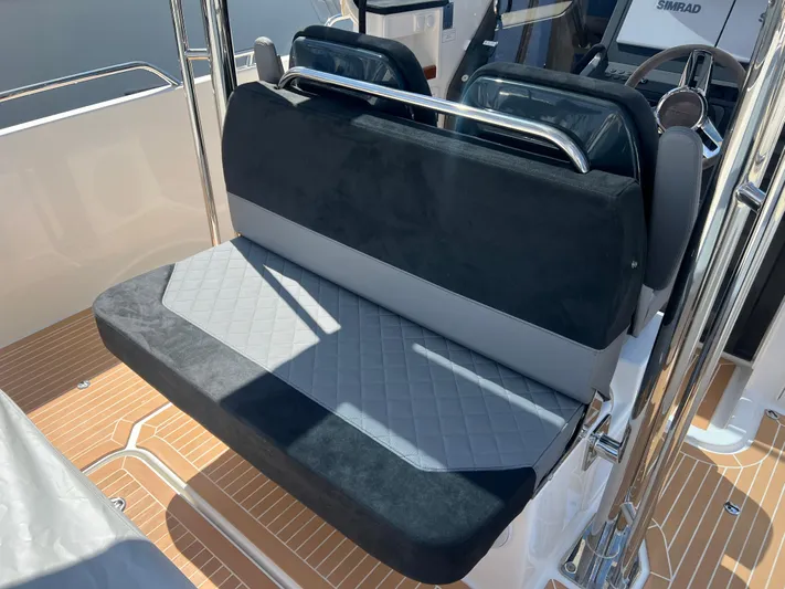 San #155 In Stock Yacht Photos Pics 2024 Nimbus T9 boat seating with sleek black and gray upholstery.