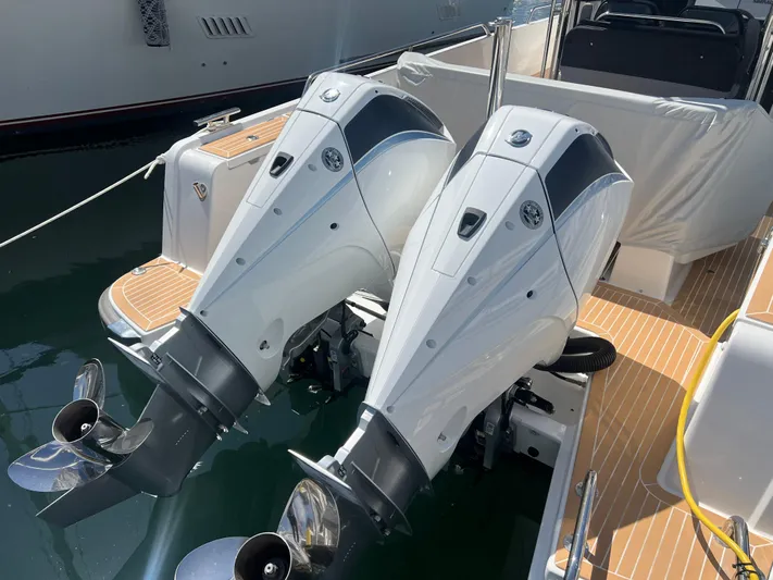 San #155 In Stock Yacht Photos Pics Twin outboard motors on a 2024 Nimbus T9 boat, docked in a marina.