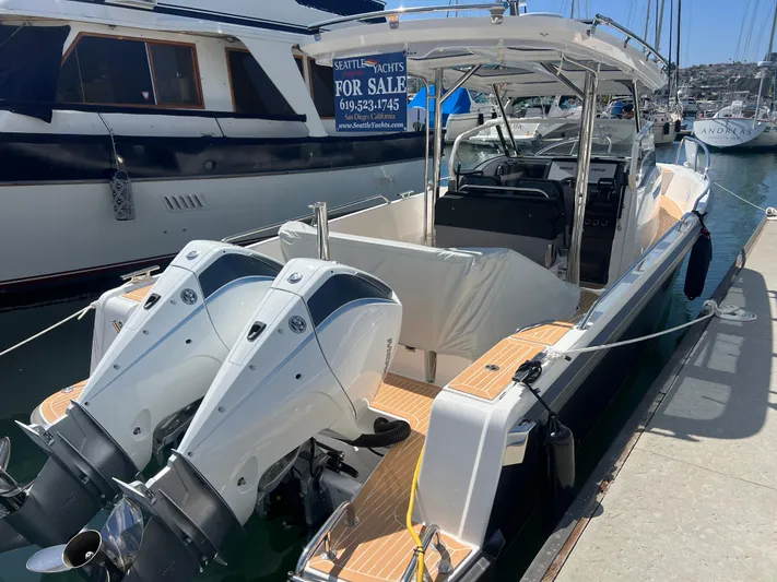 San #155 In Stock Yacht Photos Pics 2024 Nimbus T9 boat with dual engines docked, for sale sign visible.