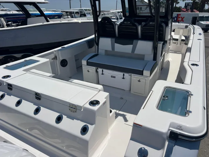  Yacht Photos Pics 2025 Robalo R300 Center Console boat interior with seating and storage compartments.