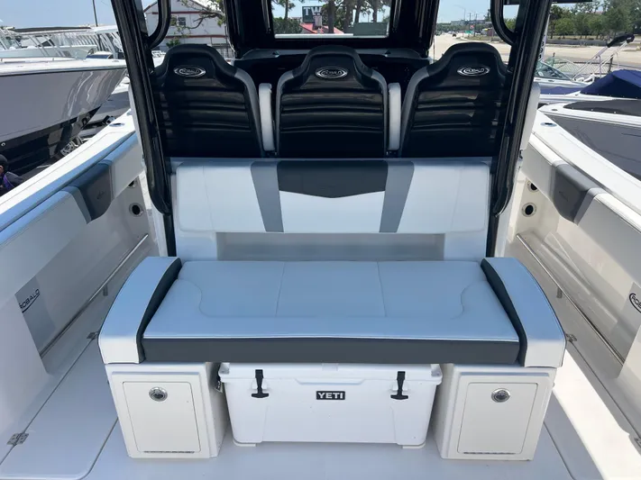  Yacht Photos Pics 2025 Robalo R300 Center Console boat interior with seating and Yeti cooler.