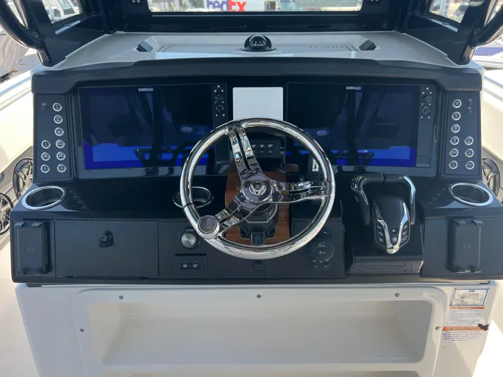  Yacht Photos Pics 2025 Robalo R300 Center Console dashboard with dual screens and steering wheel.