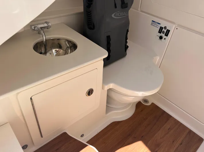  Yacht Photos Pics 2025 Robalo R300 Center Console boat interior with sink and toilet.