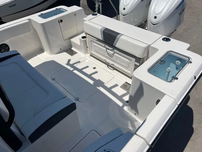  Yacht Photos Pics 2025 Robalo R300 Center Console boat interior with seating and storage compartments.